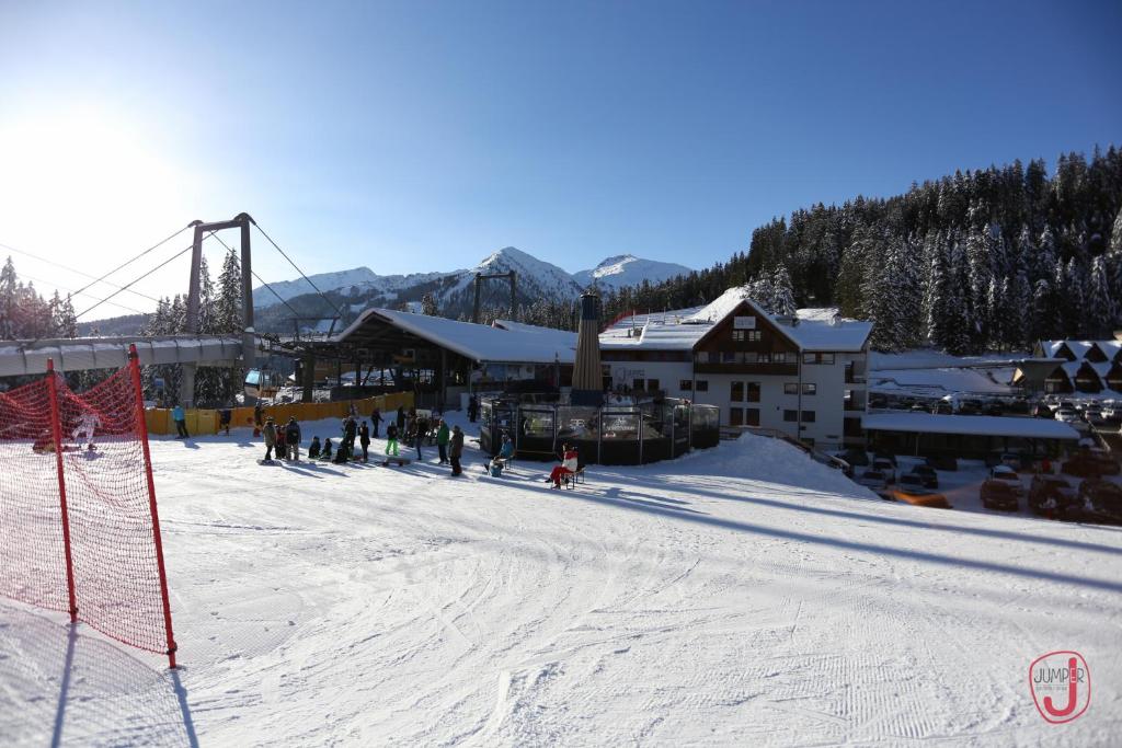 a group of people skiing down a snow covered slope at Hotel Fortini in Madonna di Campiglio