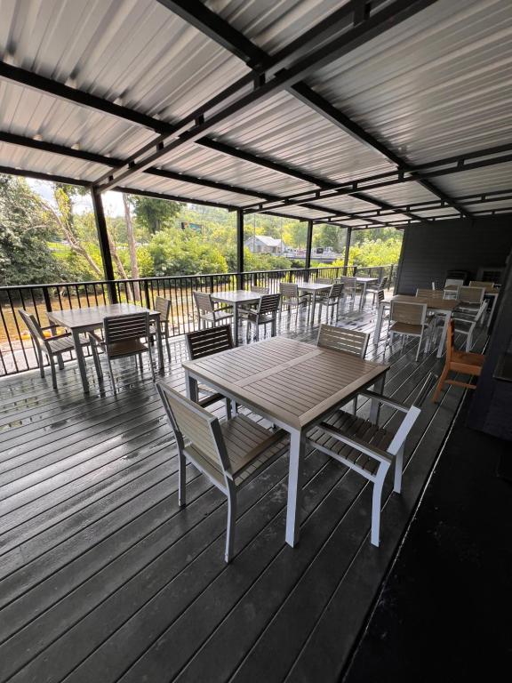 a wooden deck with tables and chairs on it at Country Inn & Suites by Radisson, Pigeon Forge South, TN in Pigeon Forge