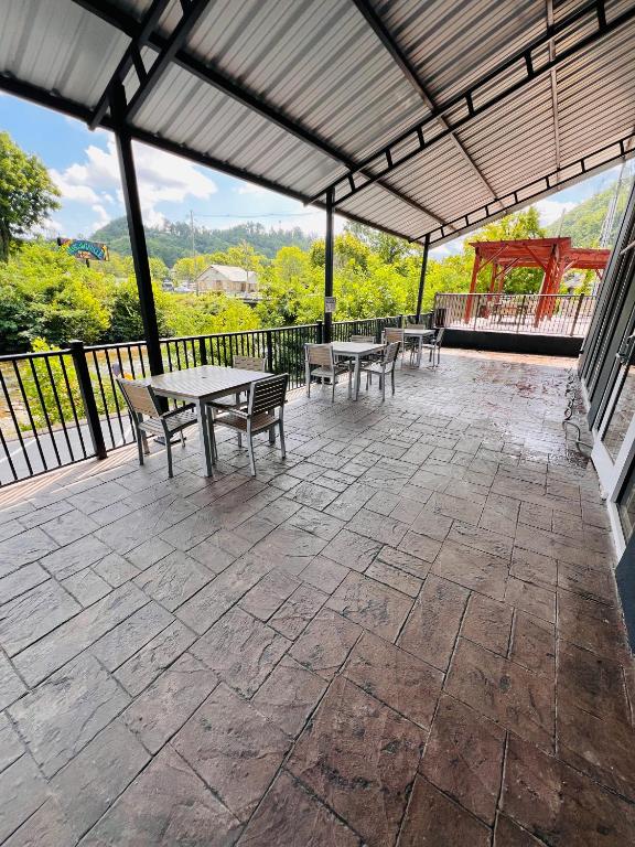 a patio with tables and chairs on a balcony at Country Inn & Suites by Radisson, Pigeon Forge South, TN in Pigeon Forge