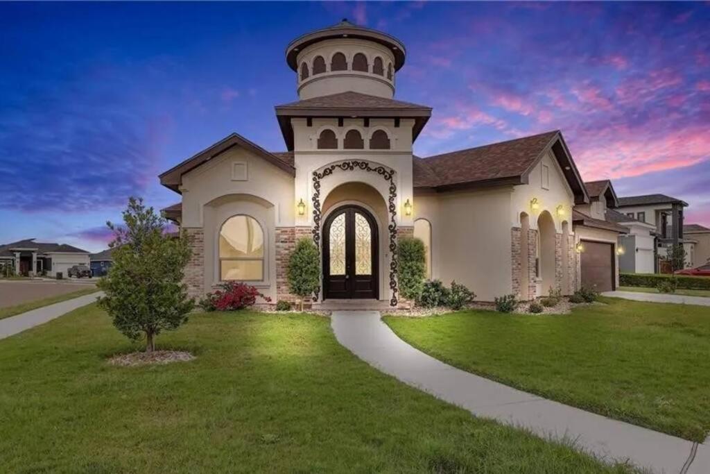 a large white house with a tower at Luxurious Gated 3BR Oasis No chore Pet friendly in Edinburg