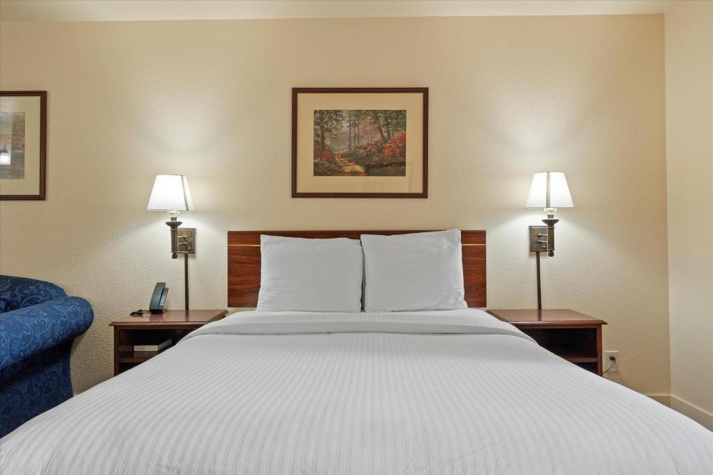 Postel nebo postele na pokoji v ubytování Quincy INN and Suites
