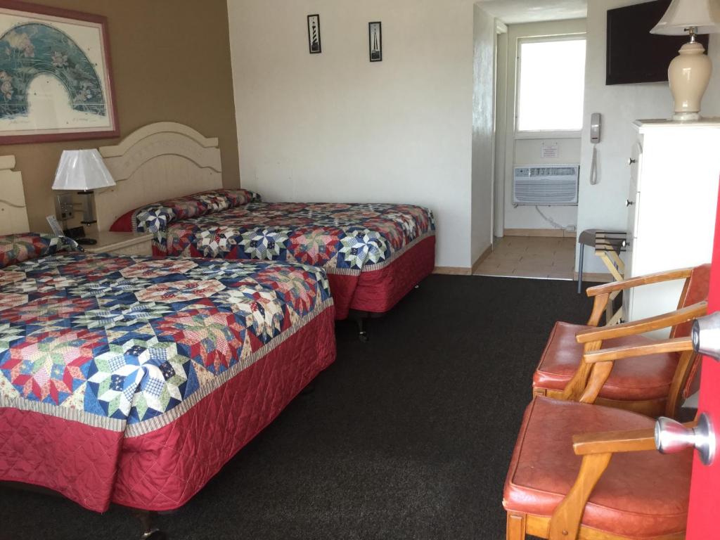 Postel nebo postele na pokoji v ubytování Starfire Motel