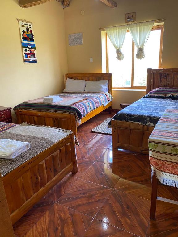 Postel nebo postele na pokoji v ubytování Casa Hotel Loma Wasi en Cotacachi