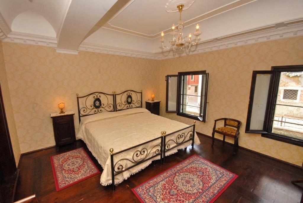 a bedroom with a bed and two rugs at Appartmento Ca' Rio Marin in Venice