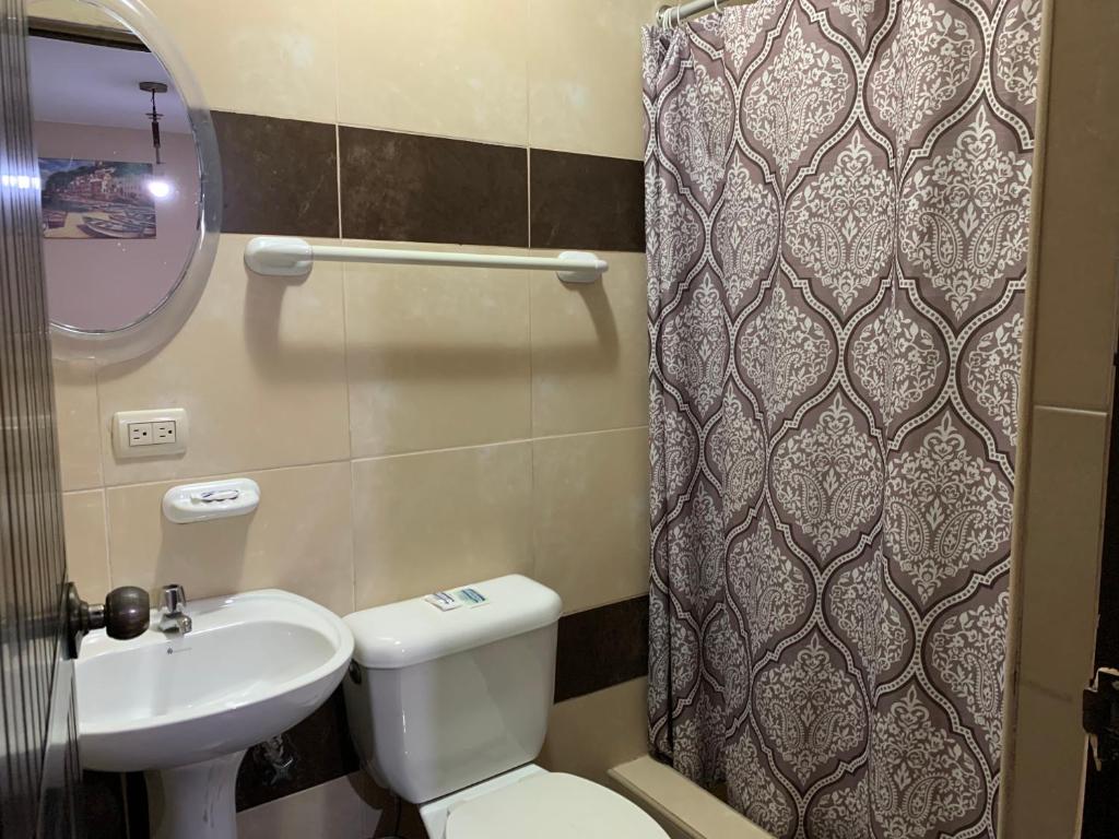 a small bathroom with a toilet and a sink at Hotel Belamar in La Libertad