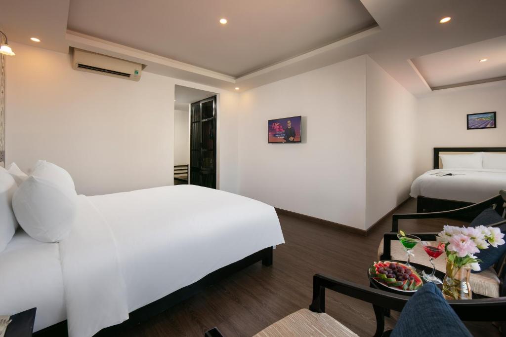 Postel nebo postele na pokoji v ubytování Hoi An Rose Garden Hotel