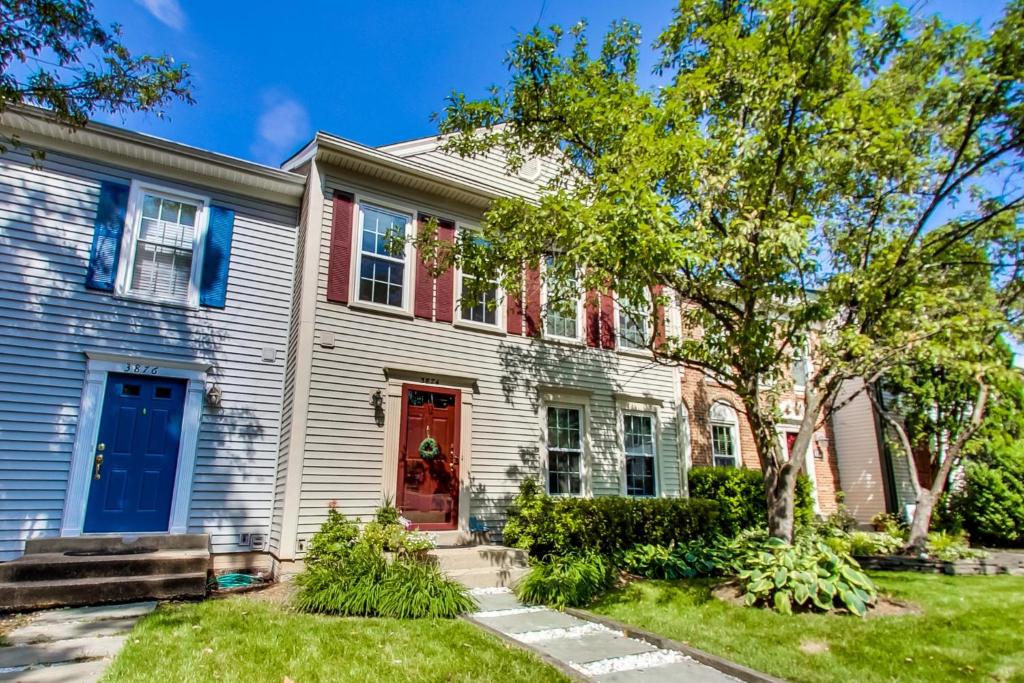 a white house with a red door at Cozy 3-bedroom townhome in Fairfax in Fairfax