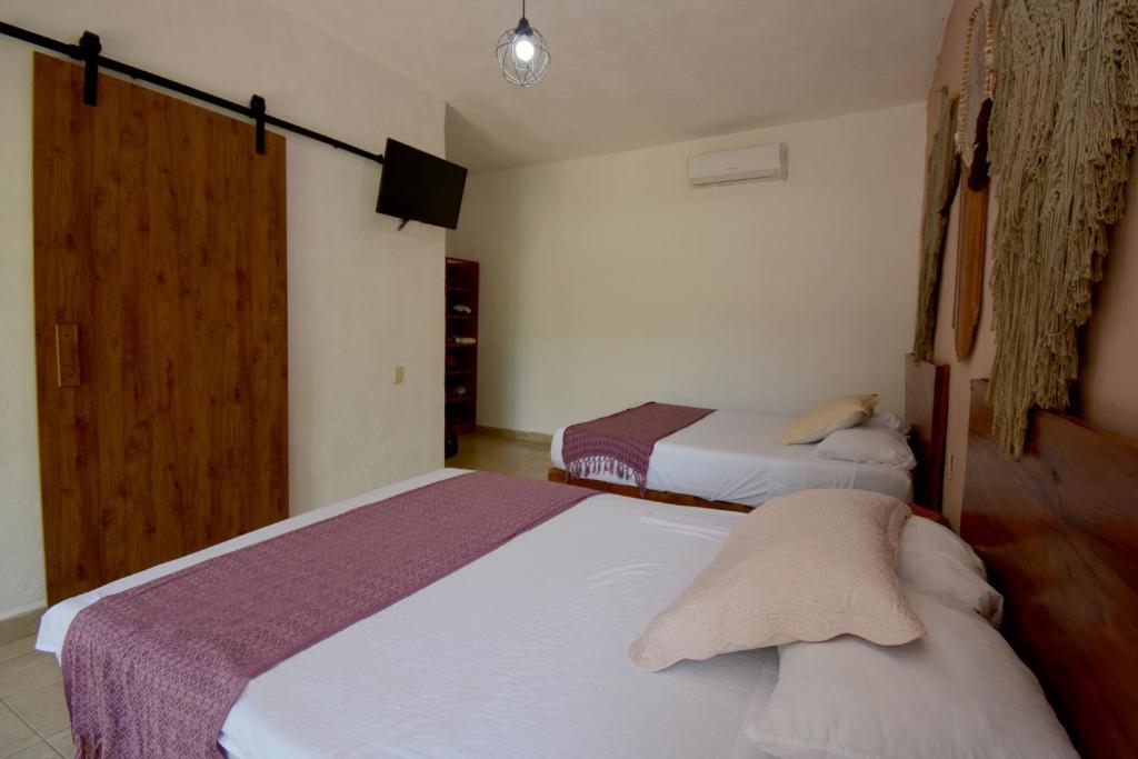 Postel nebo postele na pokoji v ubytování Casa Delia Hotel Downtown