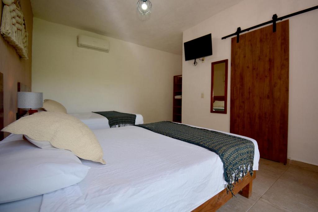 Postel nebo postele na pokoji v ubytování Casa Delia Hotel Downtown
