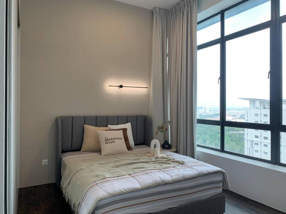 a bedroom with a bed with a large window at City Of Green near Bukit Jalil Cozy 7pax 3R2B in Seri Kembangan