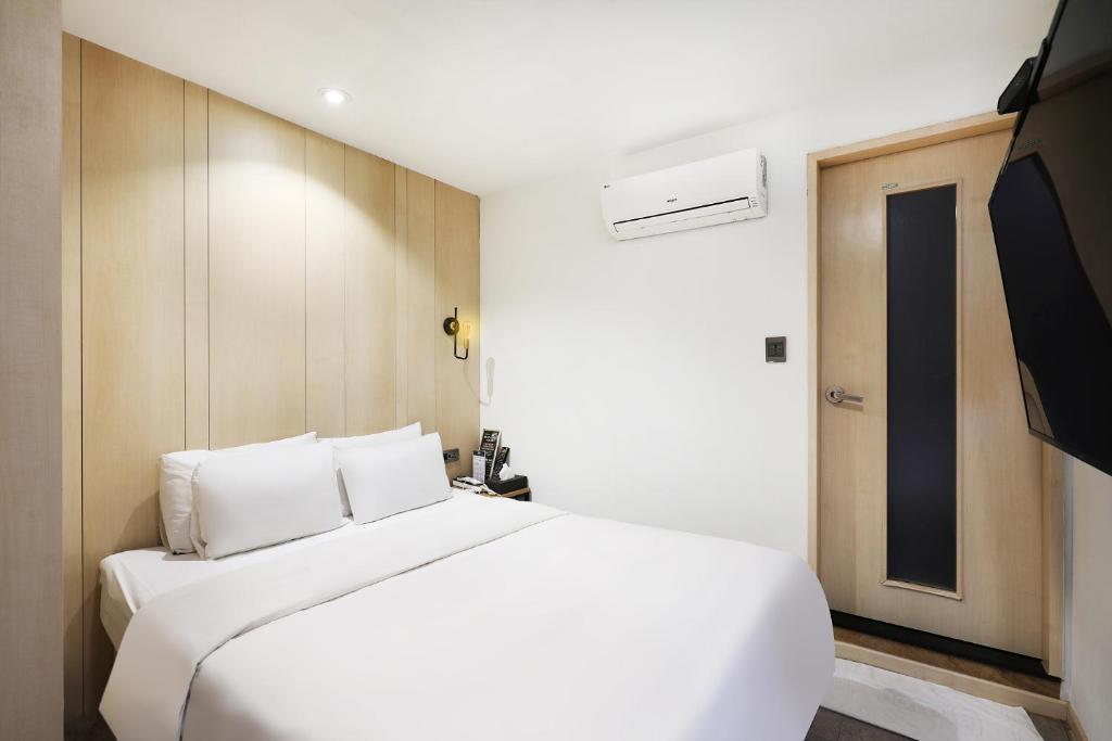 Postel nebo postele na pokoji v ubytování Pyeongtaek Moon Hotel
