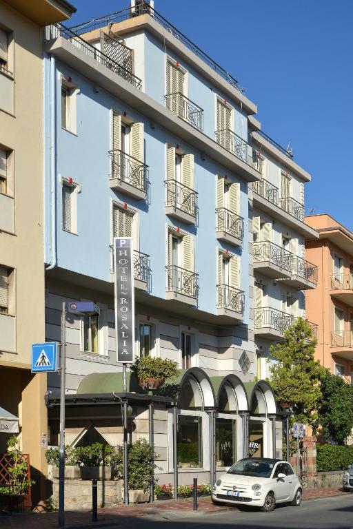 a white car parked in front of a building at Hotel Rosalia in Bordighera