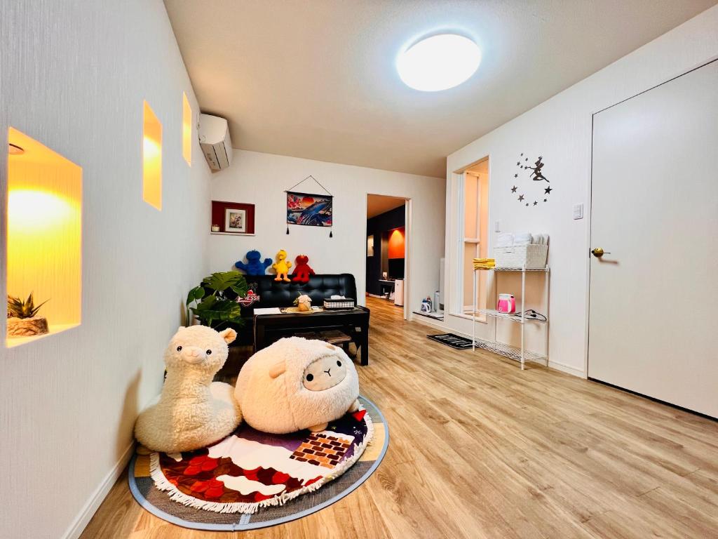 two stuffed animals sitting on a table in a room at 星の宿 in Osaka