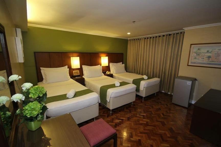 Postel nebo postele na pokoji v ubytování Comfy Inn Manila-Kalaw