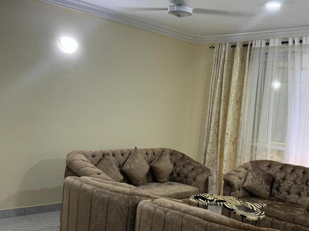 a living room with a couch and a chair at La Casa di Mtwapa in Mtwapa