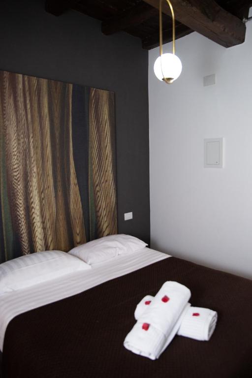Postel nebo postele na pokoji v ubytování Vicolo delle Belle Suite