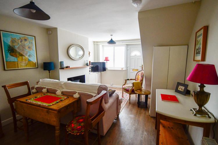 a living room with a couch and a table at Cosy cottage in Bridport centre in Bridport
