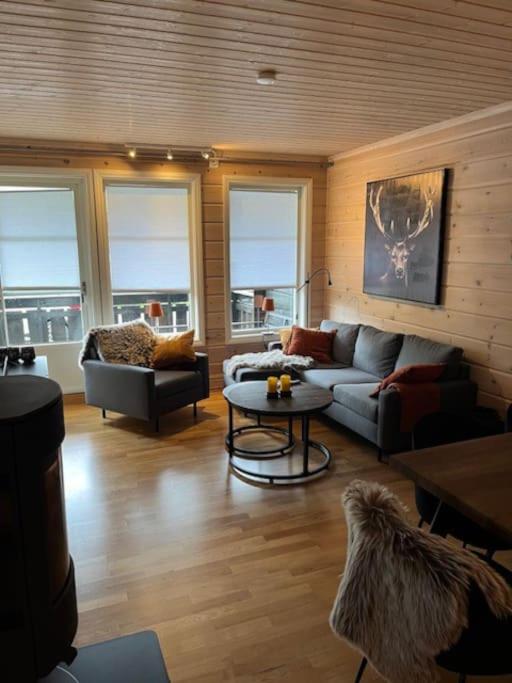 a living room with a couch and a table at Leilighet på Tyinkrysset in Tyinkrysset