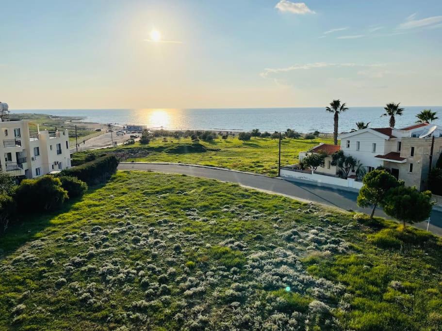 a view of the ocean from a balcony of a house at Apartments with a luxurious location near the sea in Paphos