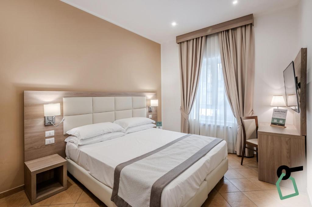 a bedroom with a bed and a desk and a window at Residenza Scarlatti Napoli in Naples