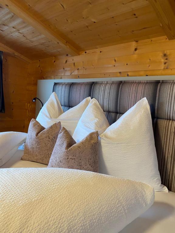 a bed with white pillows on top of it at LH Apartment in Reith im Alpbachtal
