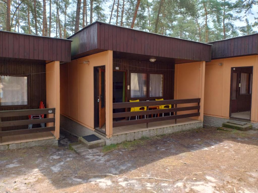 a small house with a porch and a door at Chata Borůvka u Máchova jezera - free PADDLEBOARD in Doksy