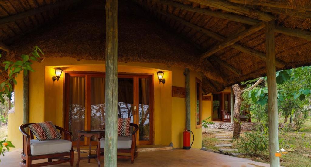 a porch of a house with a table and chairs at Nzuri House in Nairobi