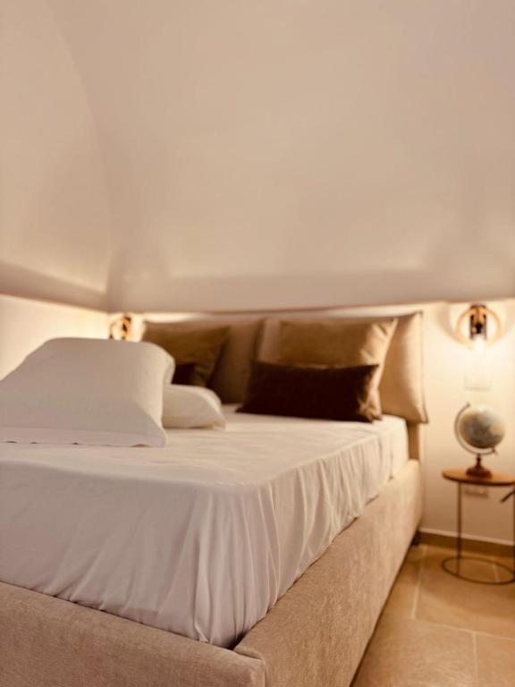 a bedroom with a bed with white sheets and pillows at La dimora del faro in Bari