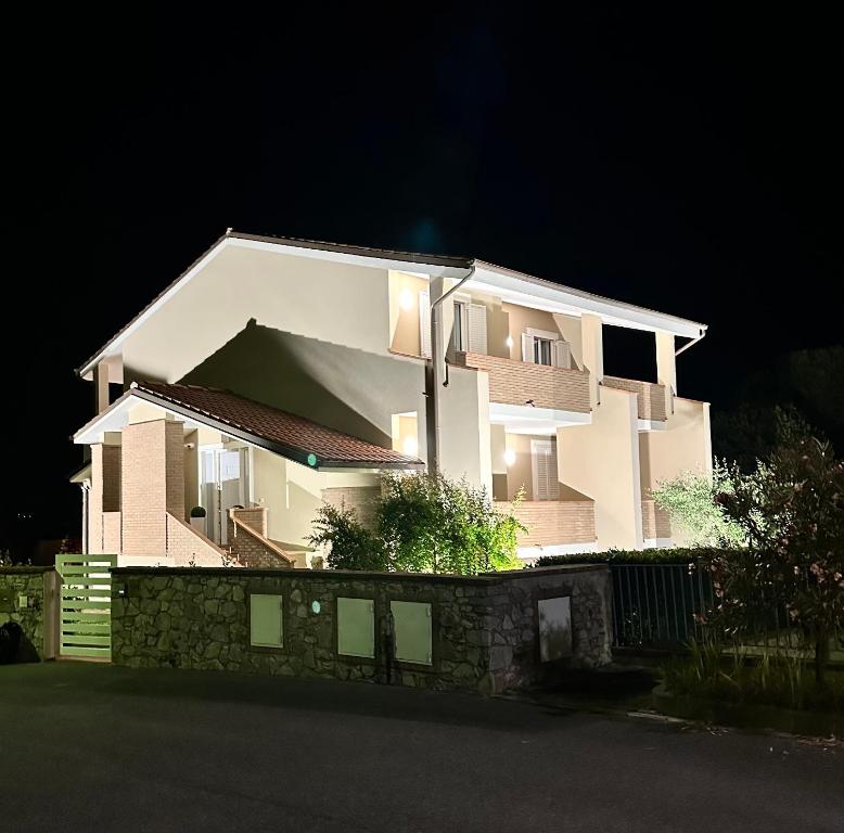 a white house with a fence in front of it at Villa Cattleya in Casciana Terme