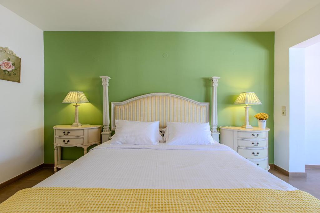 a bedroom with a large bed with two night stands at Platanias Memories Apartment in Platanias