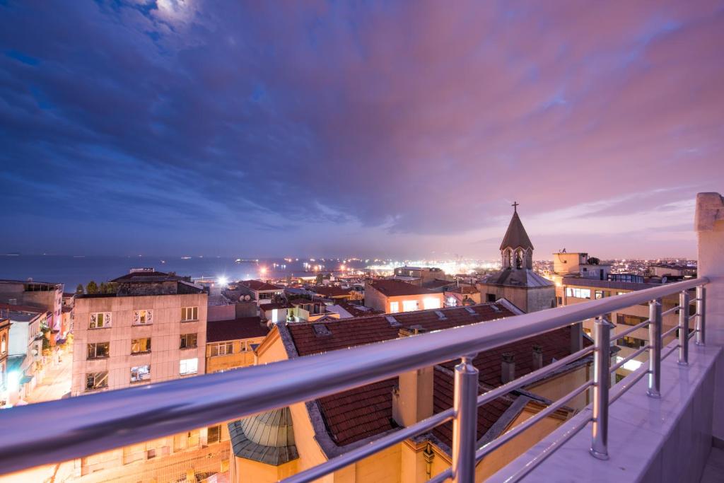 a view of a city at night from a balcony at Oban Suites Istanbul in Istanbul