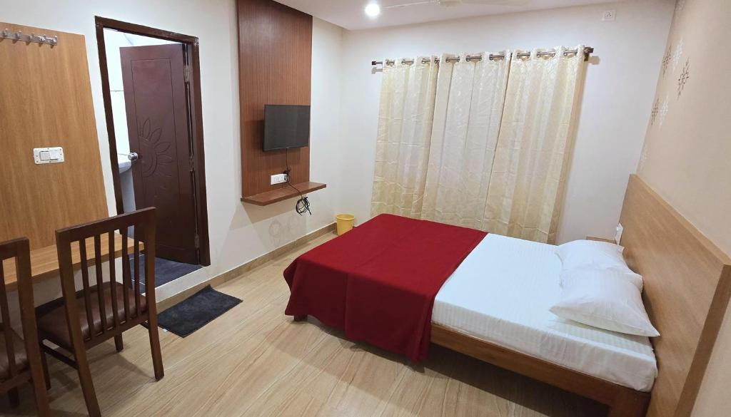Postel nebo postele na pokoji v ubytování Nandan Residency