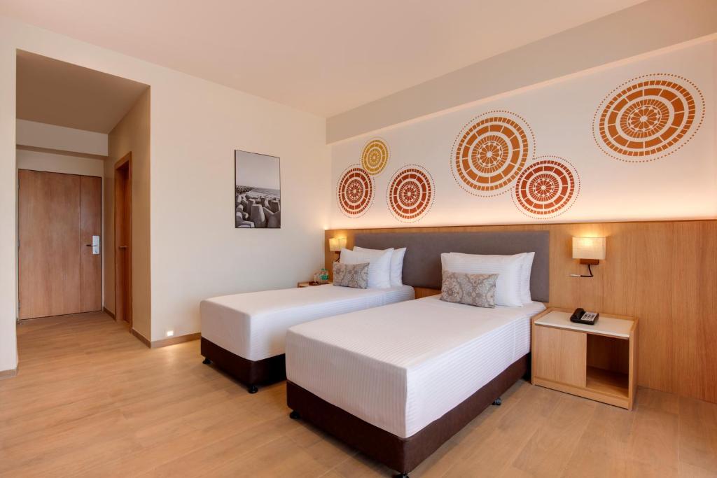 Postel nebo postele na pokoji v ubytování Lemon Tree Resort, Somnath