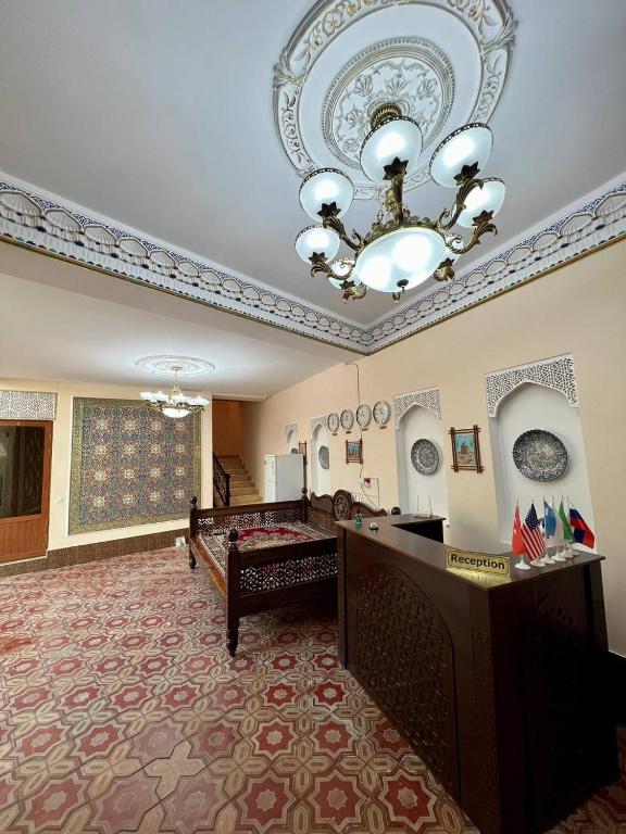 a large room with a chandelier on the ceiling at Muhtasham in Bukhara