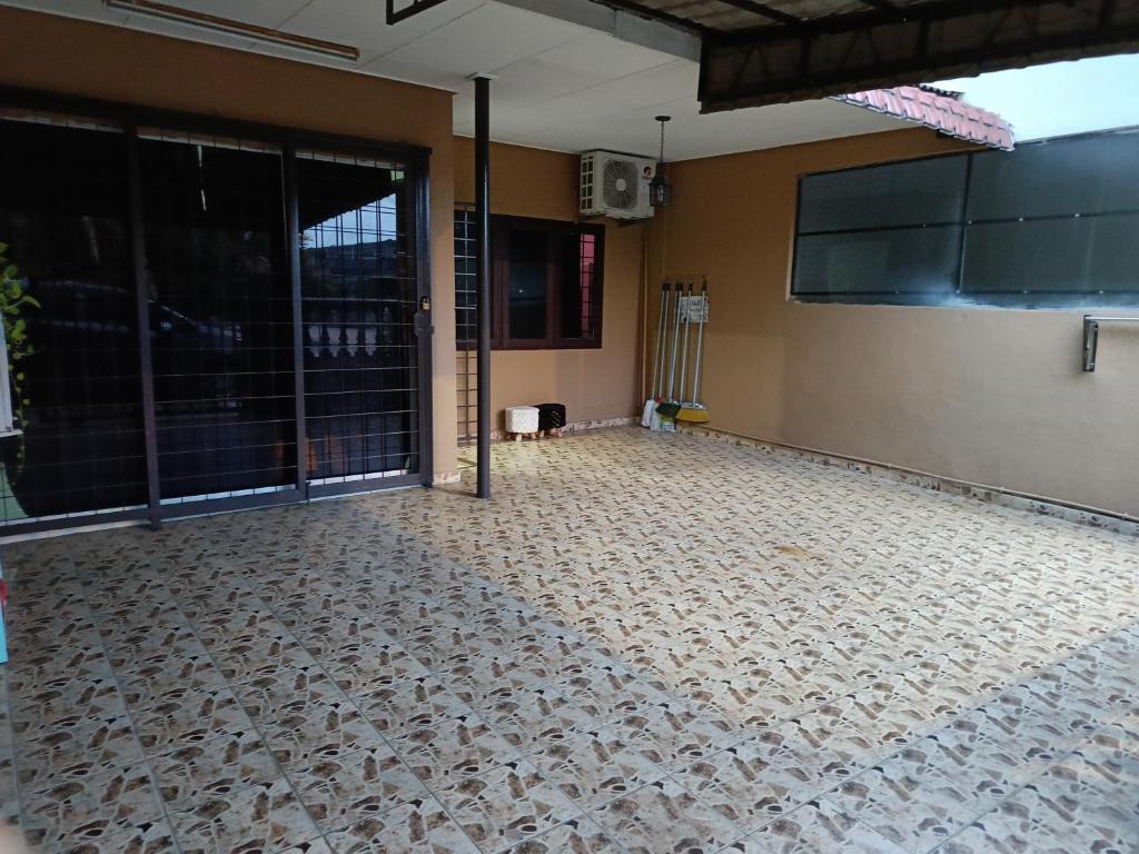an empty room with a large glass door at Lin's Homestay in Port Dickson