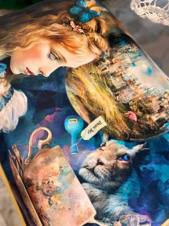 a book with a picture of a woman and a dog at Apartament ,,Kraina Alicji'' in Wałbrzych