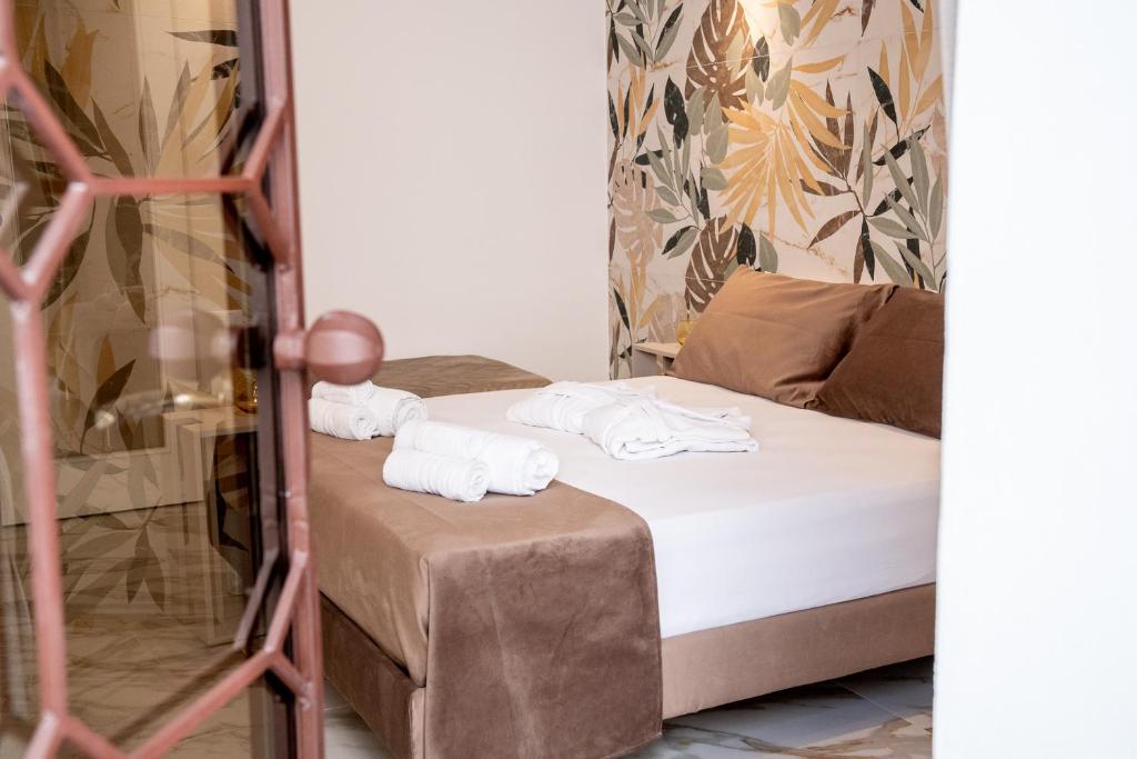 Postel nebo postele na pokoji v ubytování La Bella Ostuni Suites