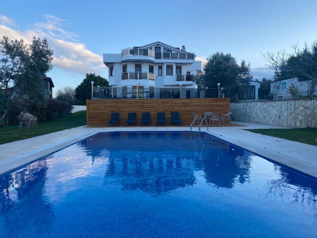 a house with a swimming pool in front of a house at Nefes URLA Villa in Urla