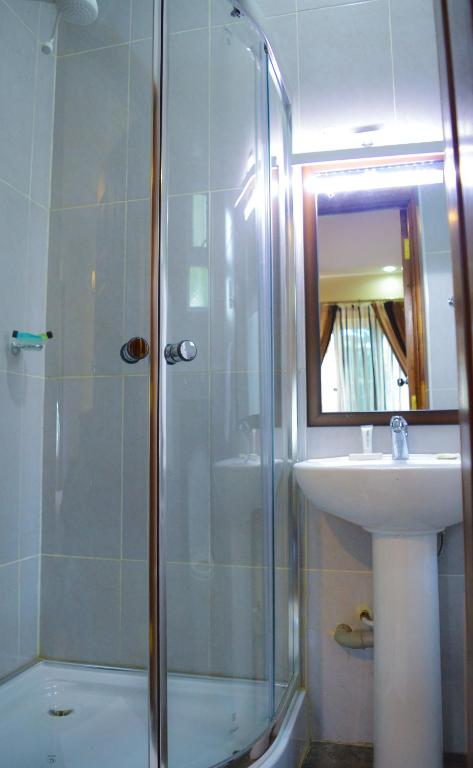 a bathroom with a shower and a sink at Red Ruby Hotel in Nairobi