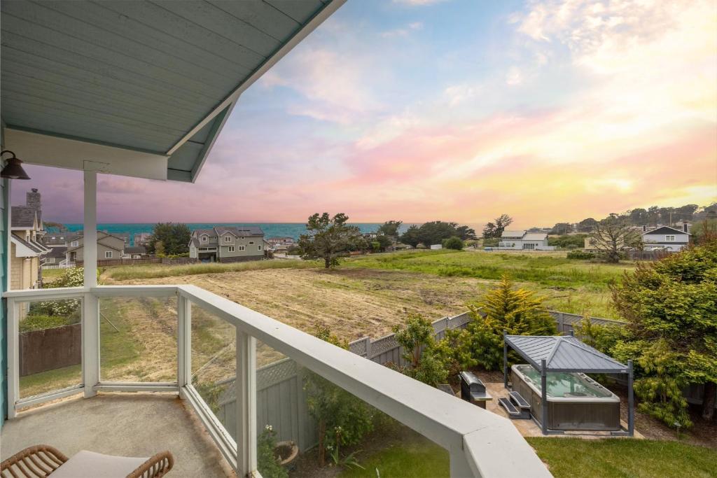 a balcony view of the ocean from a house at Coastal Dream - 2 Blocks to ocean, steps to beach, hot tub, coastal trail, BBQ in Half Moon Bay