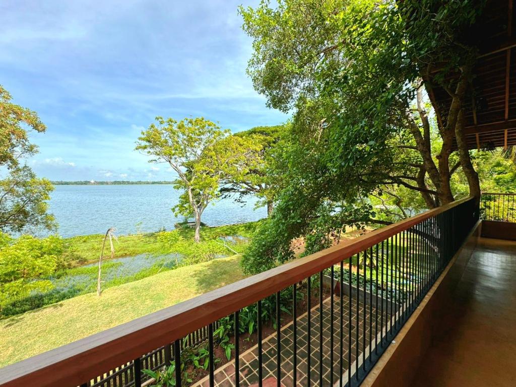 a balcony with a view of the water at Art Yala Boutique Resort in Tissamaharama