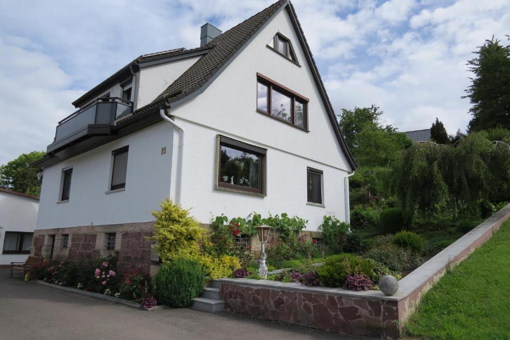 a white house with windows and a yard at Ferienhaus Johanna in Schmalkalden