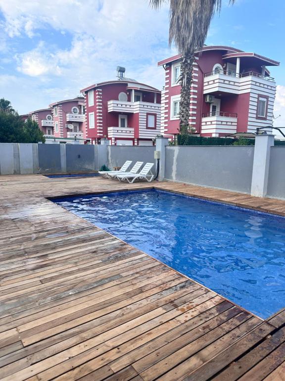 a swimming pool in front of a house at Happy Land Belek in Belek