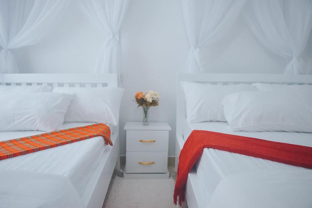 Postel nebo postele na pokoji v ubytování Saruni Homes