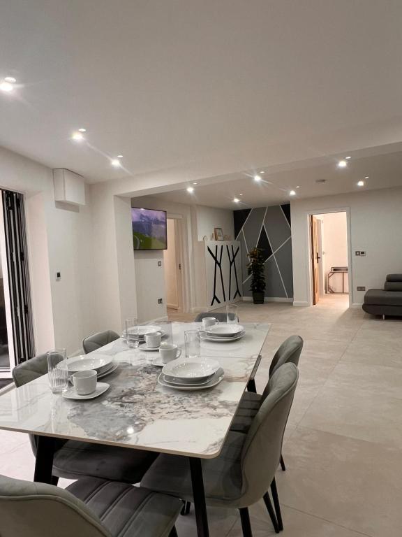 a dining room with a table and chairs at Mote Park View in Kent