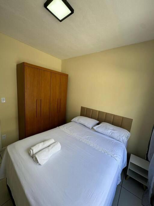 a bedroom with a bed with two towels on it at Apto no centro de nova friburgo 1 in Nova Friburgo