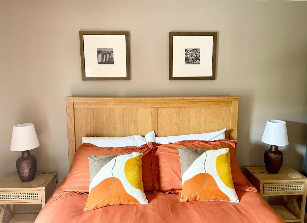 a bedroom with a bed with orange and white pillows at 3 bed house near York centre with off road parking in York