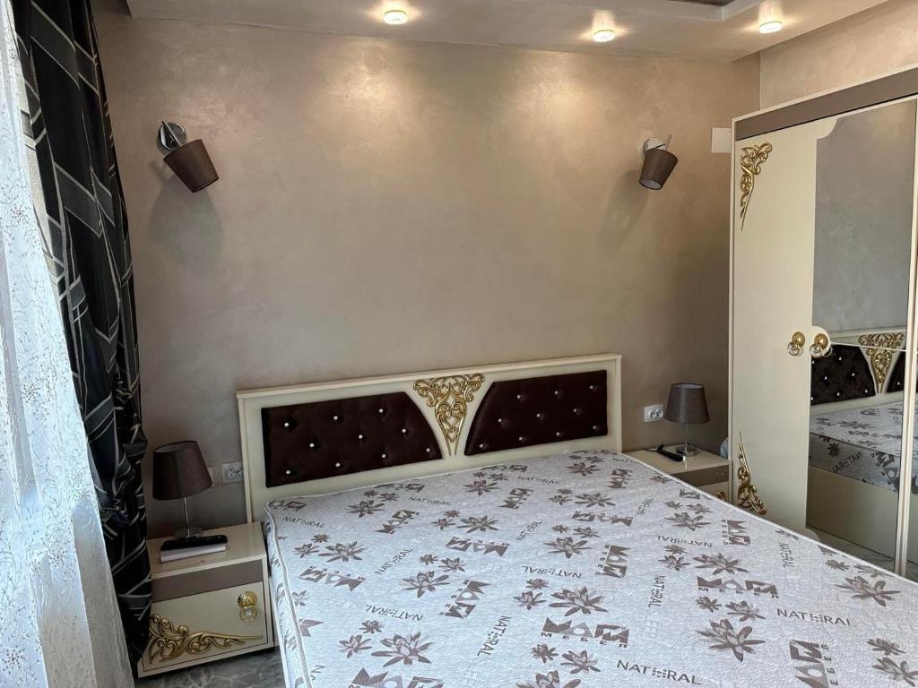 a bedroom with a bed with a white bedspread at AR Luxury VIP Apartments Ravda in Ravda