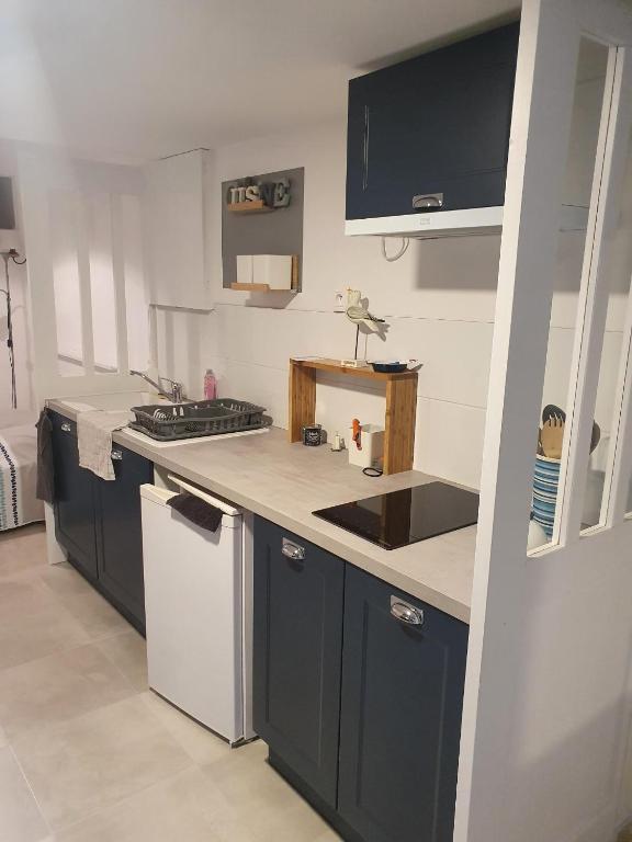 a kitchen with a sink and a counter top at Joli studio décoré proximité cure centre ville in Rochefort