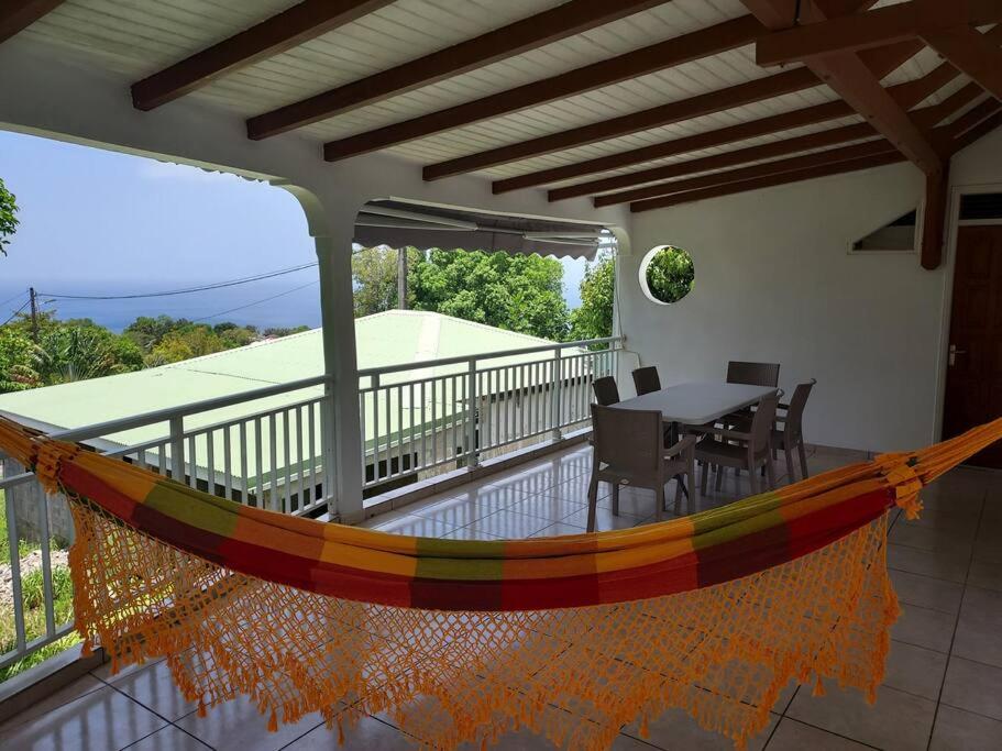 a balcony with a table and chairs on it at Sunshine Villa in Pointe-Noire